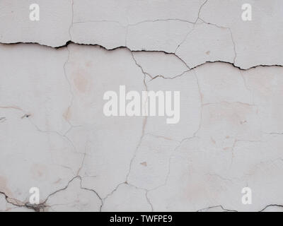Cracks on the plastered wall surface. Abstract background texture concept Stock Photo