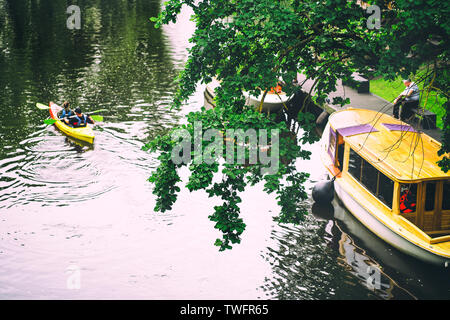 Kayaks and pleasure boats on the city canal in the city of Riga in summer Stock Photo