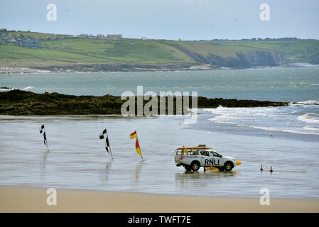 RNLI Lifeguard vehicle pictured on a deserted Coney Beach, Porthcawl, South Wales. Stock Photo