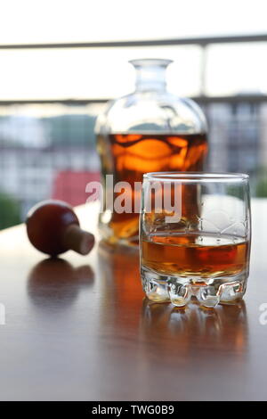 A glass of brandy on a wooden table Stock Photo