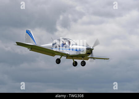 Clean looking Aerotechnik Eurostar EV-97 Light Sport Aircraft coming into land at Popham Airfield near Basingstoke in Hampshire England Stock Photo