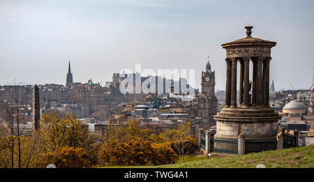 Elevated view of part of Edinburgh city centre featuring the Dugald Stewart monument, the Balmoral Hotel, Edinburgh Castle, New College, Scotland. Stock Photo