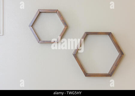 Hexagon shaped floating shelves empty on wall Stock Photo