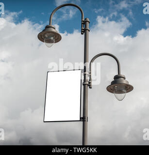 White blank rectangular billboard on a lamppost on a cloudy sky background. Stock Photo