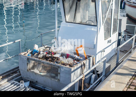 Special service vessel for collecting garbage from the water surface. Selective focus. Stock Photo