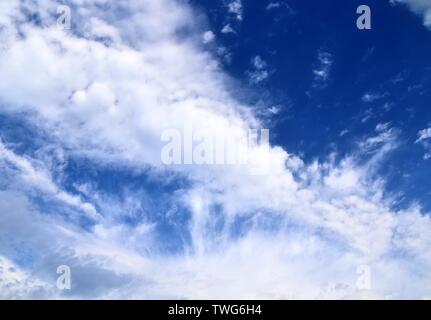 Beautiful mixed white and dark cloud formations on a blue sky Stock Photo