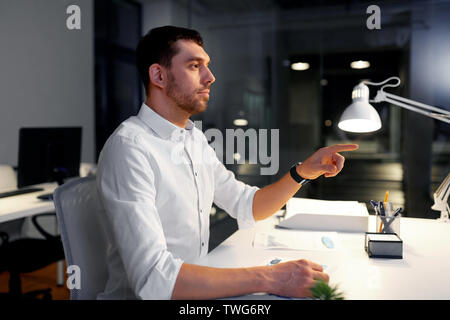 businessman using gestures at night office Stock Photo