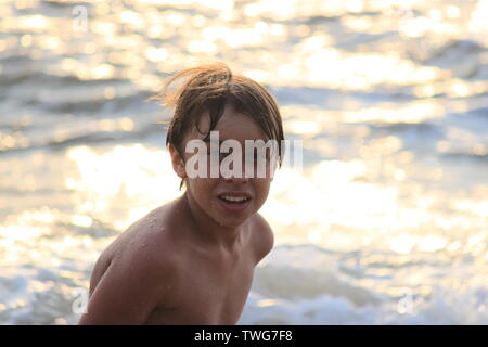 Young boy playing in the sea in Sri Lanka Stock Photo