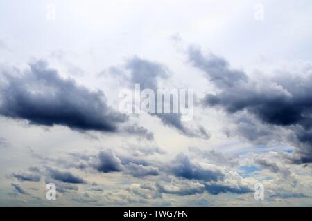 Beautiful mixed white and dark cloud formations on a blue sky Stock Photo