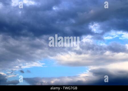 Beautiful mixed white and dark cloud formations on a blue sky Stock Photo