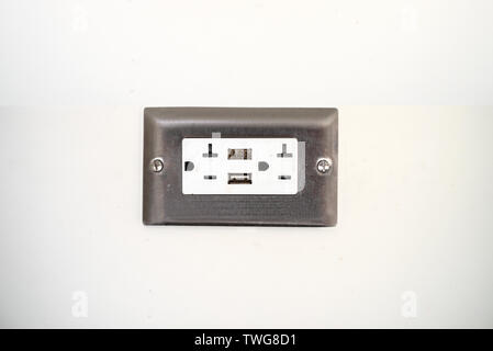 AC power plug  outlet type B and USB on the white wall of an airport in the USA Stock Photo