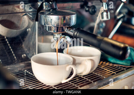 Coffee Maker making coffee flowing in two cup Stock Photo