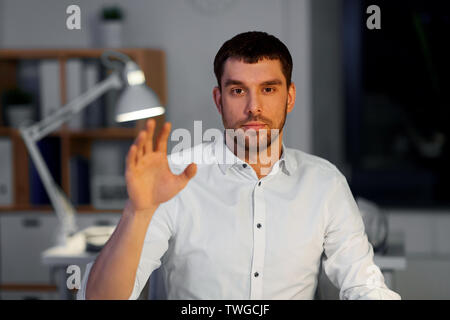 businessman using gestures at night office Stock Photo