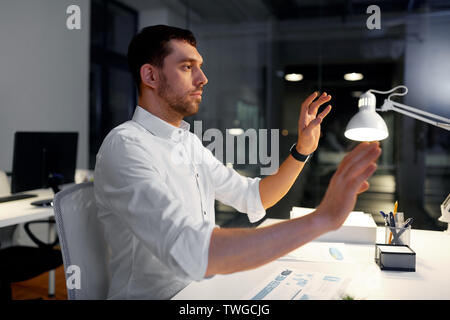 businessman using gestures at night office Stock Photo