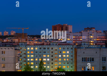 Windows, roofs and facade of an mass apartment buildings in Russia at evening Stock Photo