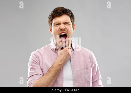 screaming man suffering from sore throat Stock Photo
