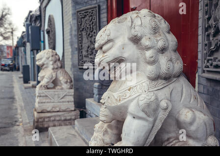 Lion statues in traditional hutong residential area in Dongcheng district of Beijing, China Stock Photo