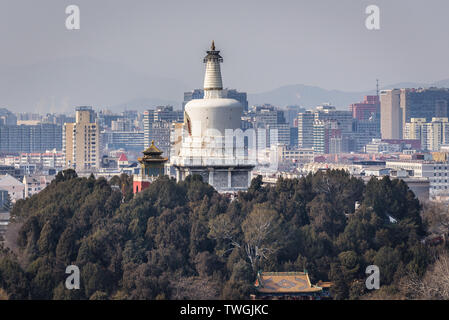 White Dagoba on Jade Flower Island in Beihai Park seen from Pavilion of Everlasting Spring Pavilion in Jingshan Park in Beijing, China Stock Photo