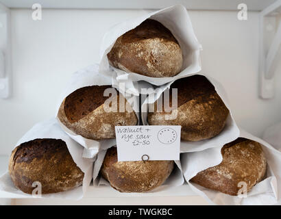 Detail of artisan loaves of bread on a shop shelf Stock Photo