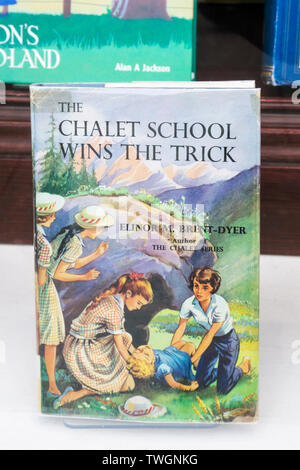 A copy of The Chalet School Wins The Trick by Elinor M. Brent-Dyer for sale in a bookshop window. One of her Chalet School series of books for girls. Stock Photo