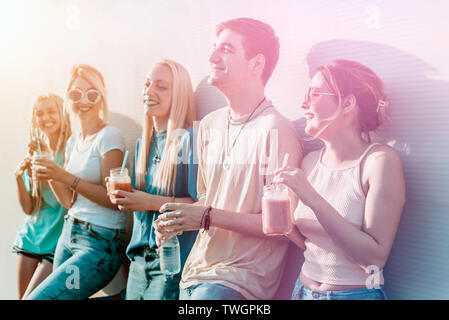 Group of young people having fun in colorful light concept Stock Photo