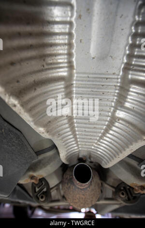 Toyota Prius, stolen Catalytic Converter. Victim of stolen exhaust system. Mechanics inspection pit, showing location of damaged components. Stock Photo
