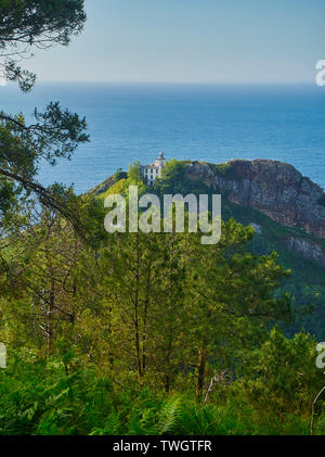 Monte Ulia Mount with the Faro de la Plata (lighthouse) and the Cantabrian Sea in background. Pasaia, Gipuzkoa, Basque country, Spain. Stock Photo