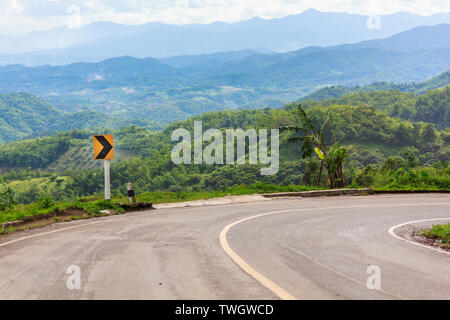 Traffic signs curve right direction on mountain highway, warning accident Stock Photo