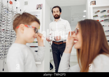 Mother with little son in the glasses store Stock Photo