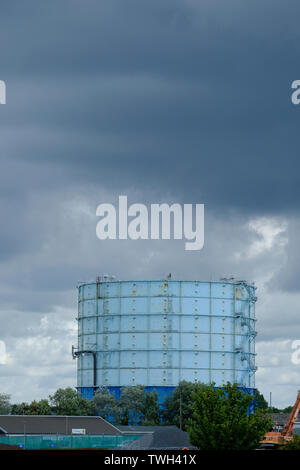 Gas holder at Littlehampton Marina, West Sussex, UK. Storm clouds forming in sky above. This gas holder is marked for demolition. Stock Photo