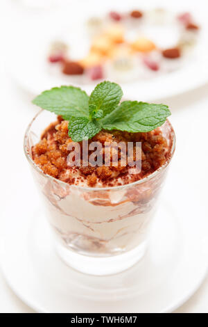 Modern style tiramisu dessert served in glass with mint Stock Photo