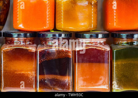 Honey market with various types of honey in jars close Stock Photo