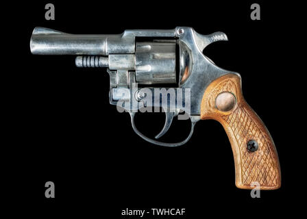 Image of an old revolver with a wood hilt on a black bakground Stock Photo