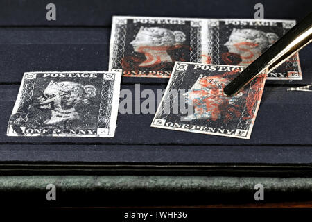 Penny Black stamps in slip-in stamp album. It is the world's first adhesive postage stamp. Stock Photo