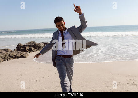 Happy Businessman dancing on the beach Stock Photo