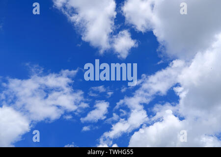 Large white clouds covering a blue sky Stock Photo