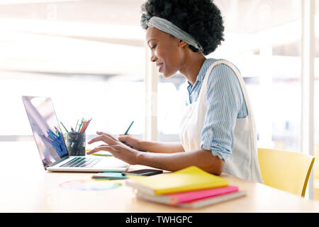 Female graphic designer using graphic tablet and laptop Stock Photo