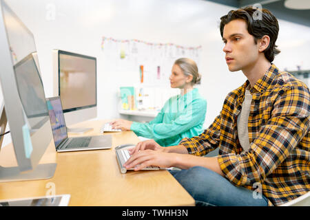 Male and female executive working on computer Stock Photo