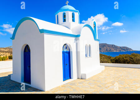White chapel on sea coast in Ammopi village, Karpathos island, Greece Stock Photo