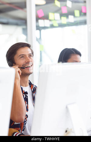 Male customer service executive working on computer at desk Stock Photo