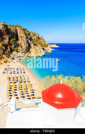 View of Kyra Pynagia beach and Greek chapel on hill top, Karpathos island, Greece Stock Photo