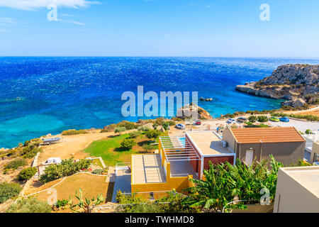 Colorful houses on sea coast of Karpathos island near Ammopi village, Greece Stock Photo