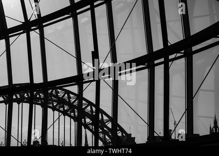 Silhouette view of Newcastle city Skyline through Sage Gateshead windows with Tyne Bridge  and other buildings at Newcastle Quayside in view Stock Photo