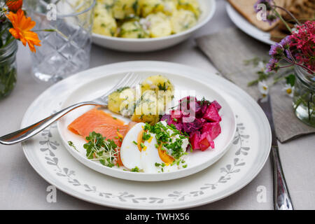 Scandinavian midsummer feast with potato salad, salmon and beetroot Stock Photo