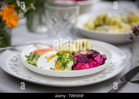 Scandinavian midsummer feast with potato salad, salmon and beetroot Stock Photo