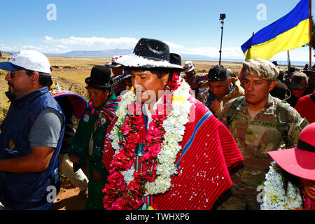 Bolivia 20th June 2019: Bolivian president Evo Morales Ayma (centre) leads an International Hike along a section of the Qhapaq Ñan Inca road from Azafranal near Lake Titicaca (which is visible in the background). The event was organised by the Ministry of Cultures & Tourism to promote tourism and Bolivia's indigenous cultures. Stock Photo