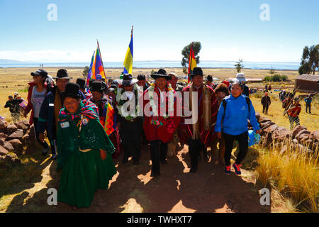 Bolivia 20th June 2019: Bolivian president Evo Morales Ayma (centre) leads an International Hike along a section of the Qhapaq Ñan Inca road from Azafranal near Lake Titicaca (which is visible in the background). The event was organised by the Ministry of Cultures & Tourism to promote tourism and Bolivia's indigenous cultures. Stock Photo