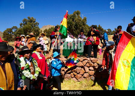 Bolivia 20th June 2019: Bolivian president Evo Morales Ayma (centre) waves a Bolivian flag as he leads an International Hike along a section of the Qhapaq Ñan Inca road near Desaguadero. The event was organised by the Ministry of Cultures & Tourism to promote tourism and Bolivia's indigenous cultures. Stock Photo