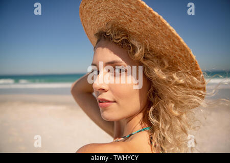 Beautiful woman standing on the beach Stock Photo