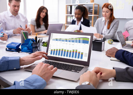 Close-up Of A Businessman Analyzing The Graph On Laptop In The Meeting Stock Photo